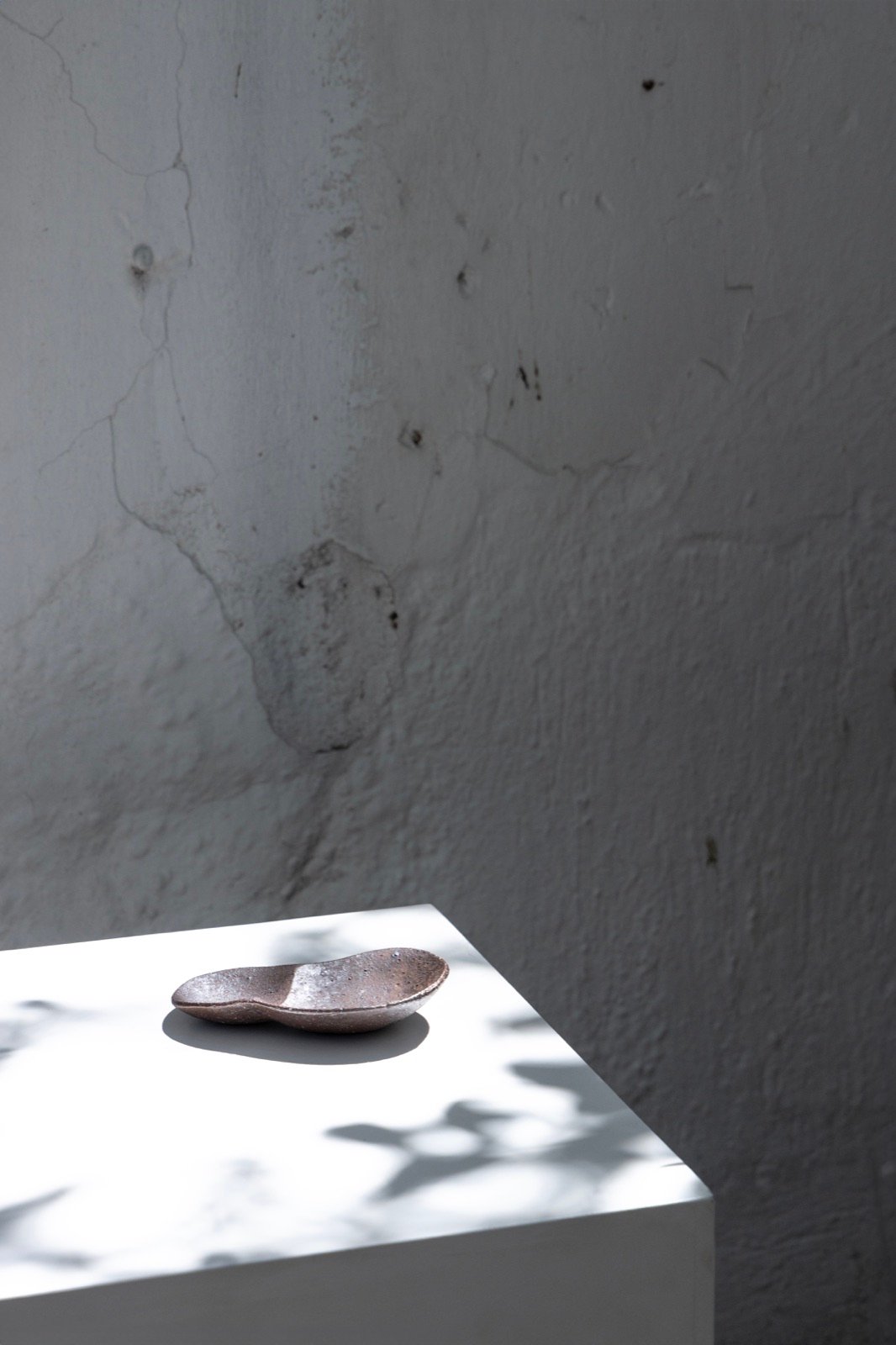 Small dish on a white plinth